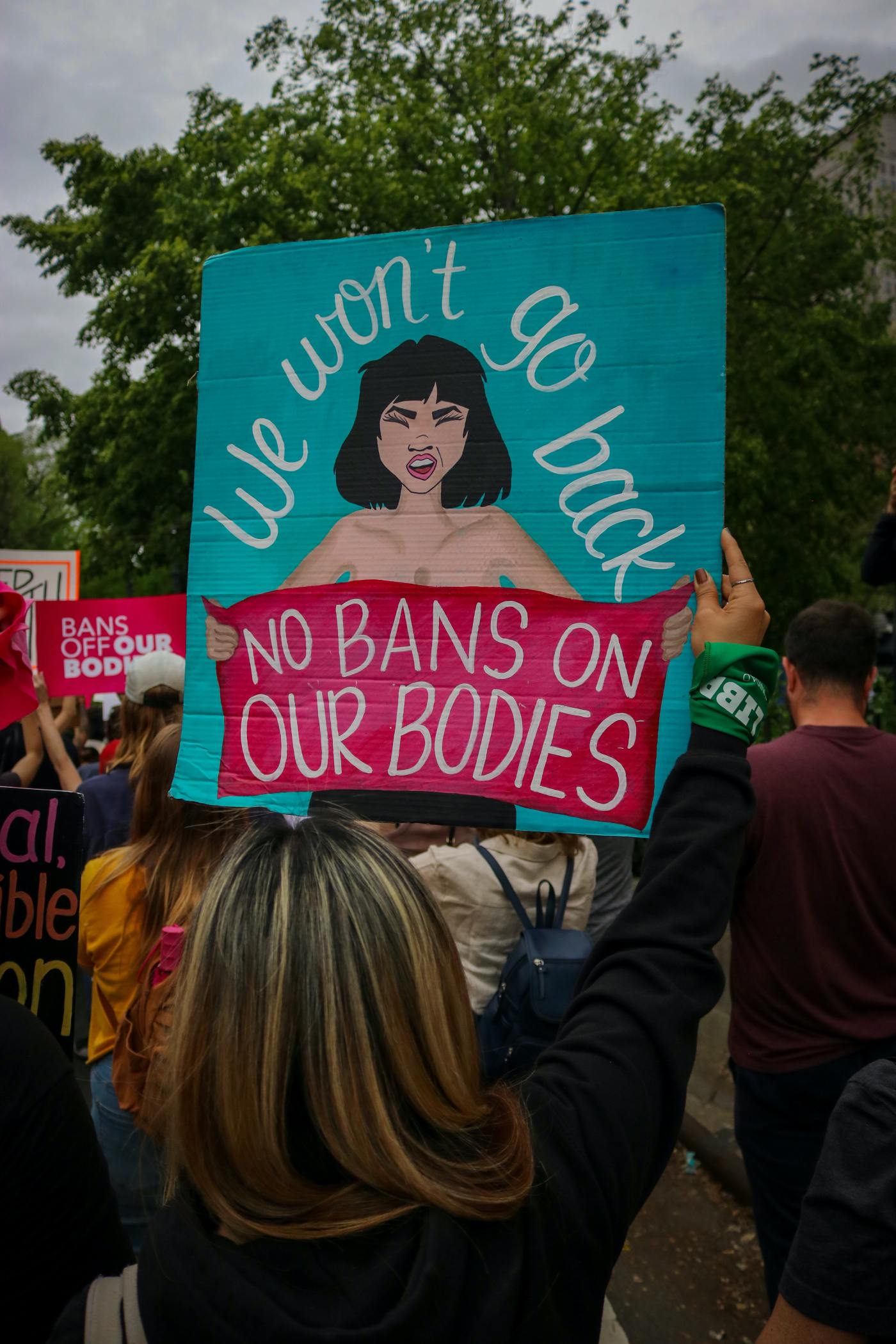 a "bans off our bodies" sign held by a woman in a pro-choice rally